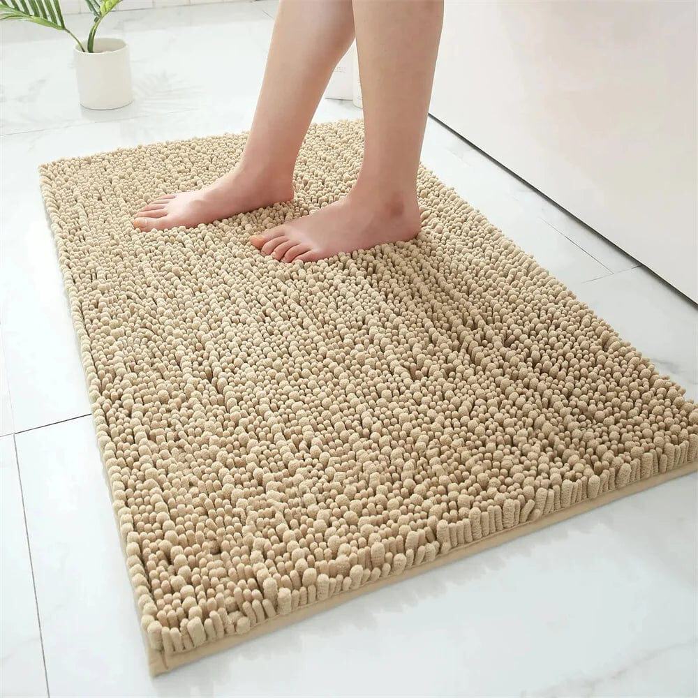 Fluffy beige bath mat with textured shaggy pile, perfect for cozy bathroom comfort.