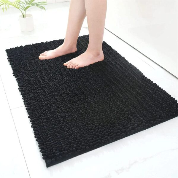Fluffy black bath mat with textured pom-pom design for comfort and style.