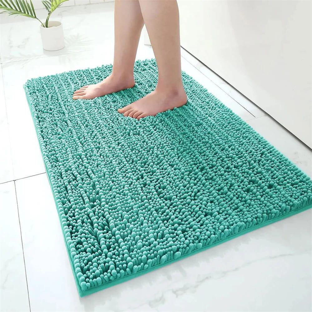 Fluffy teal bath mat with textured loops for comfort and grip.