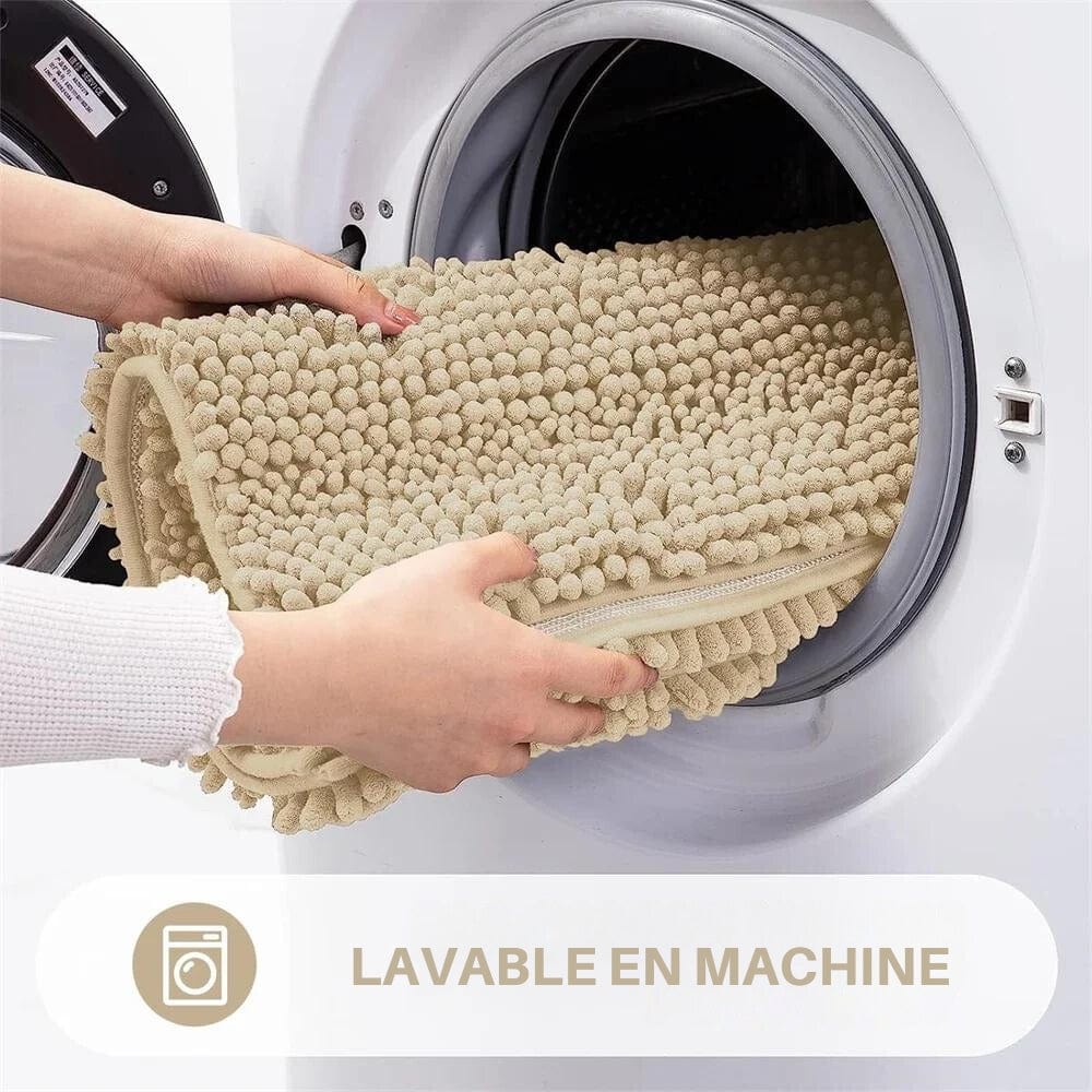 Fluffy bath mat being placed in washing machine for easy cleaning.