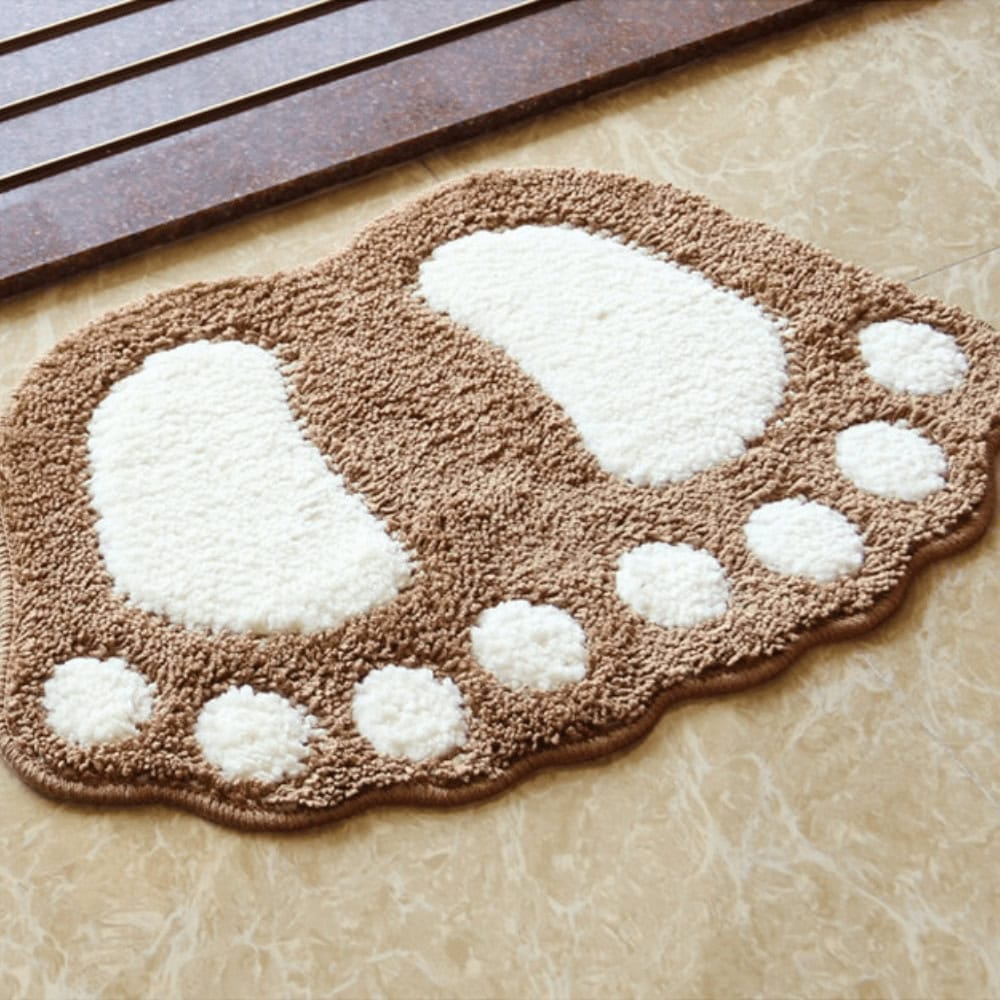 Foot shaped bath mat with brown and white fluffy design.