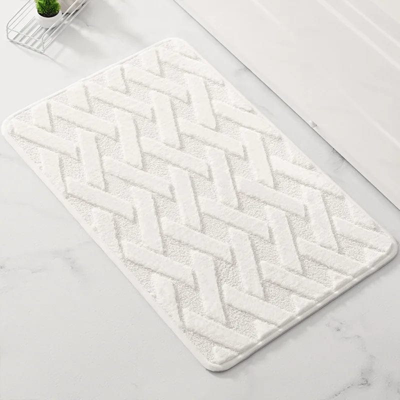 White geometric pattern bath mat with herringbone design for modern bathroom.