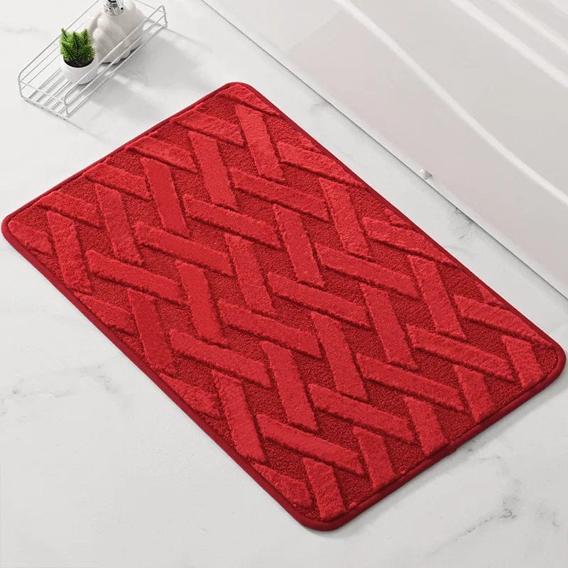 Red geometric pattern bath mat for bathroom decor.