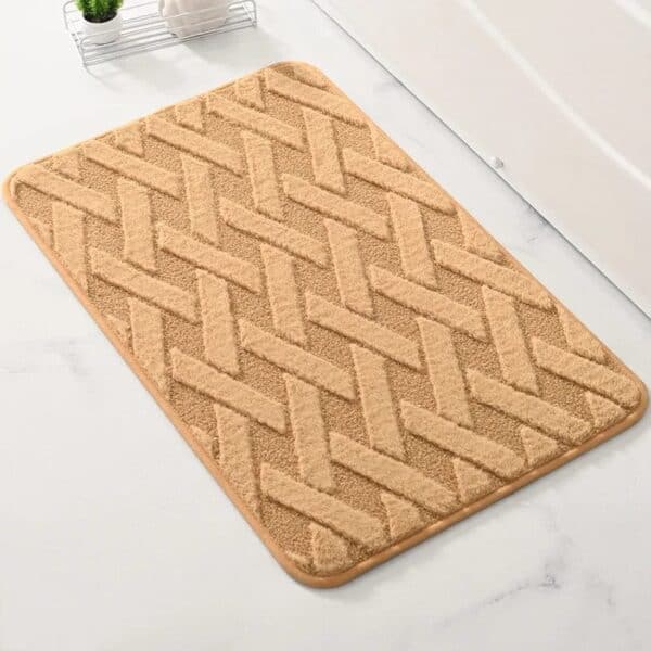 Geometric pattern bath mat with herringbone design in beige.