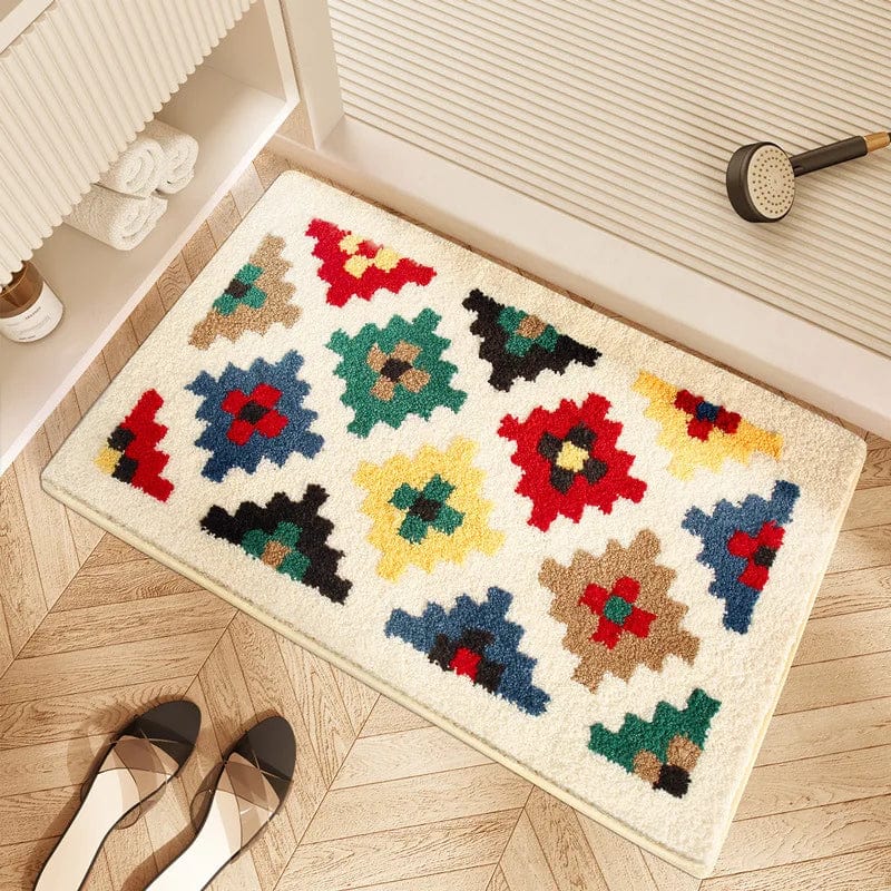 Geometric print bath mat with colorful pixelated patterns on wooden floor.
