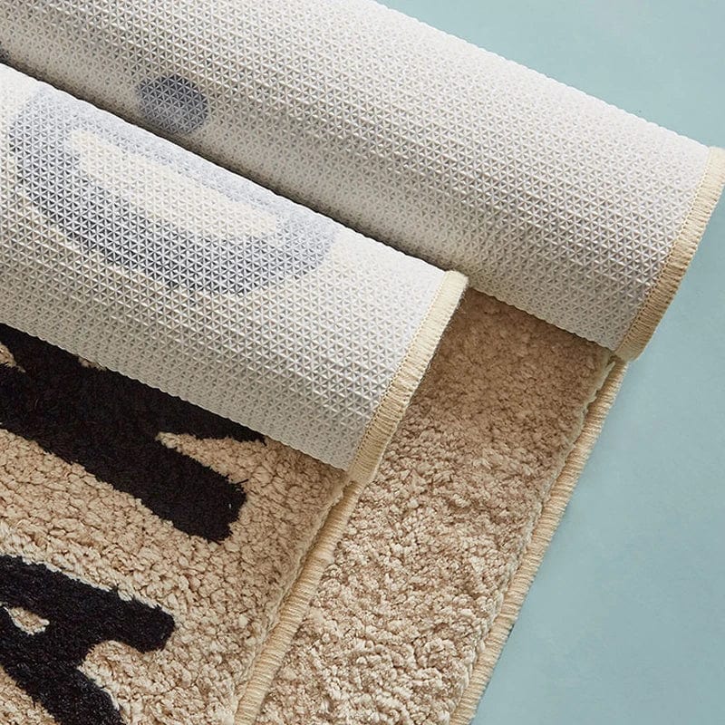 Get Naked Bath Mat Urban - plush beige rug with black abstract design.