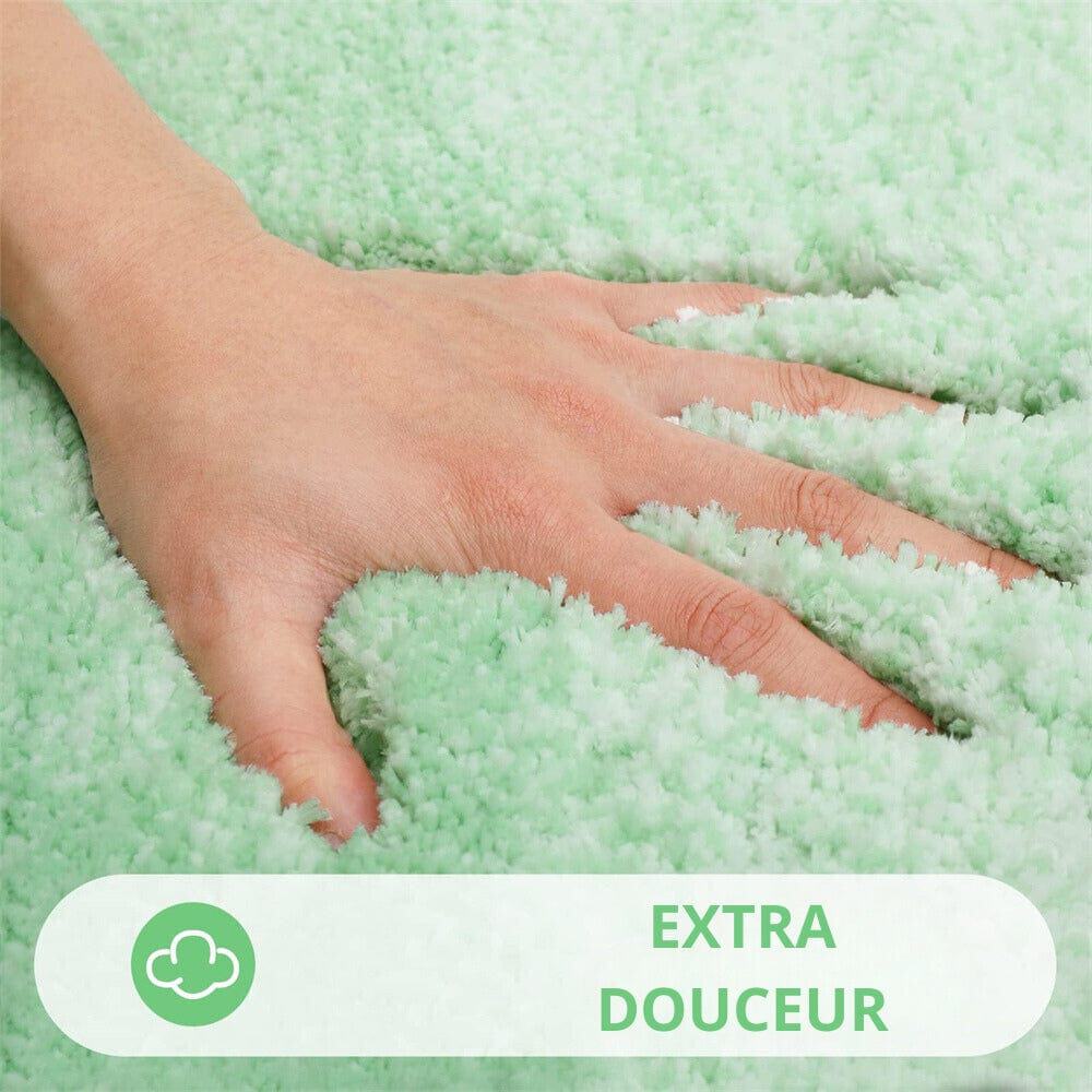 Soft green and white fluffy bath mat with hand touching texture.