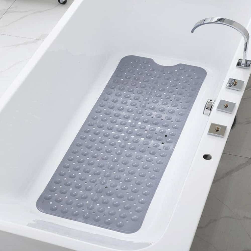 Grey non-slip bath mat with raised dots for safety in bathtub.