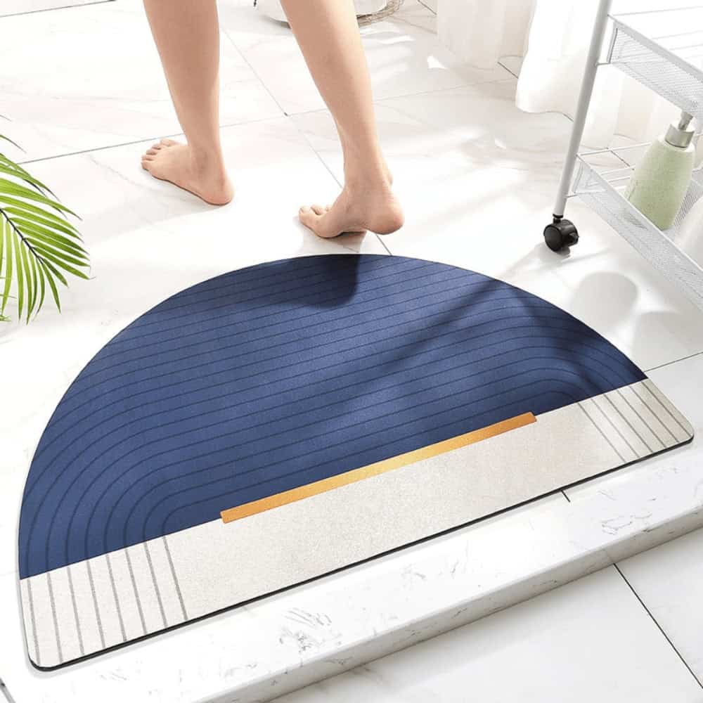 Half circle bath mat with blue and beige stripes, modern bathroom design.