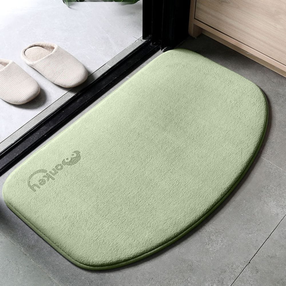 Grey half moon bath mat with logo, soft texture, bathroom floor.