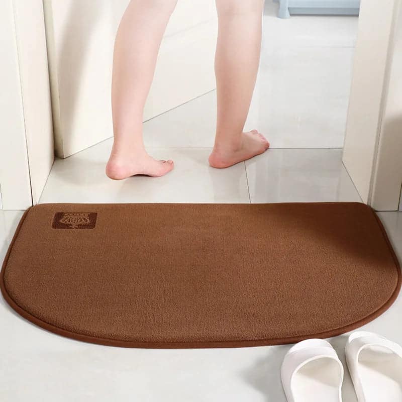 Brown halfmoon bath mat for bathroom comfort and style.