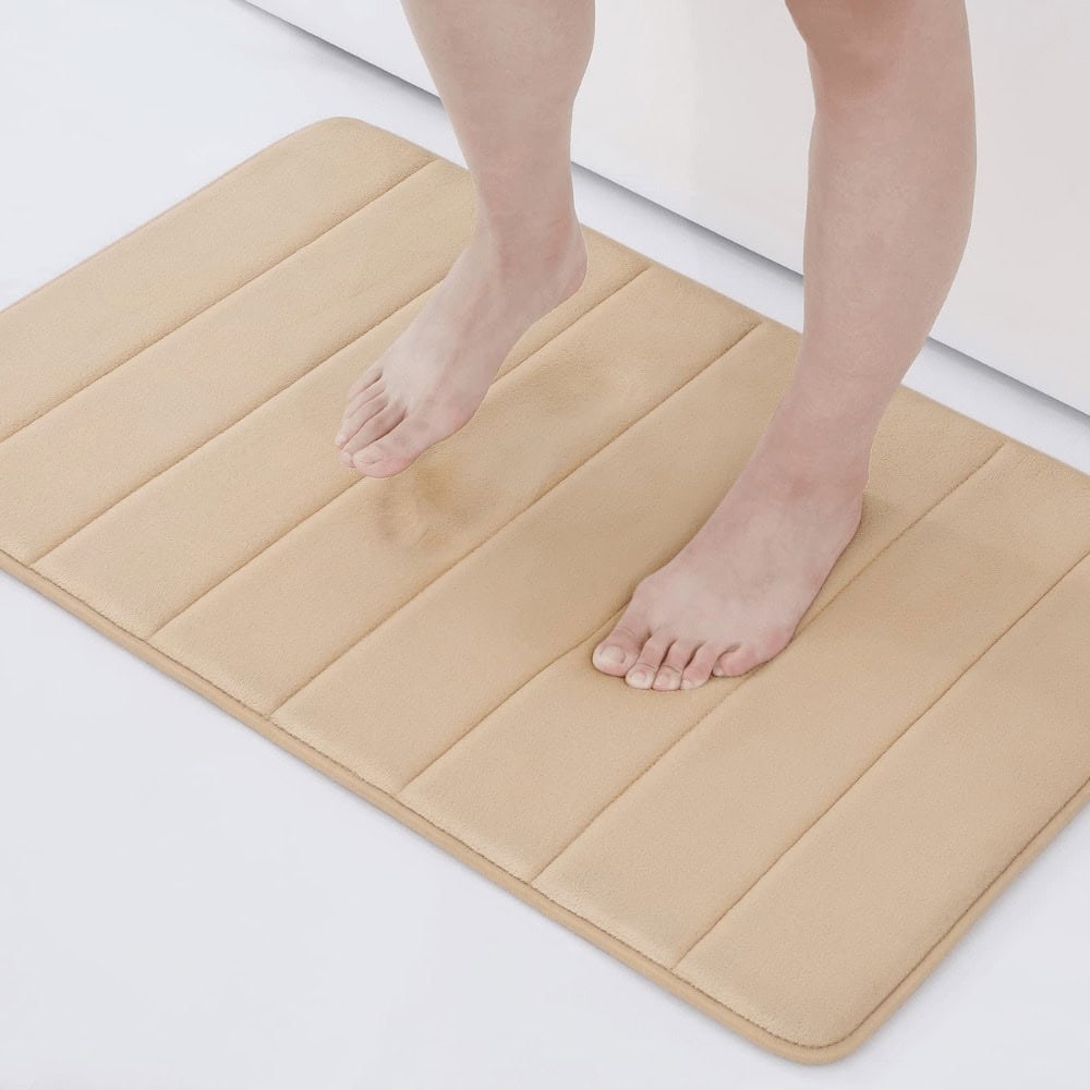 Large fluffy beige bath mat with cushioned ridges for comfort and grip.
