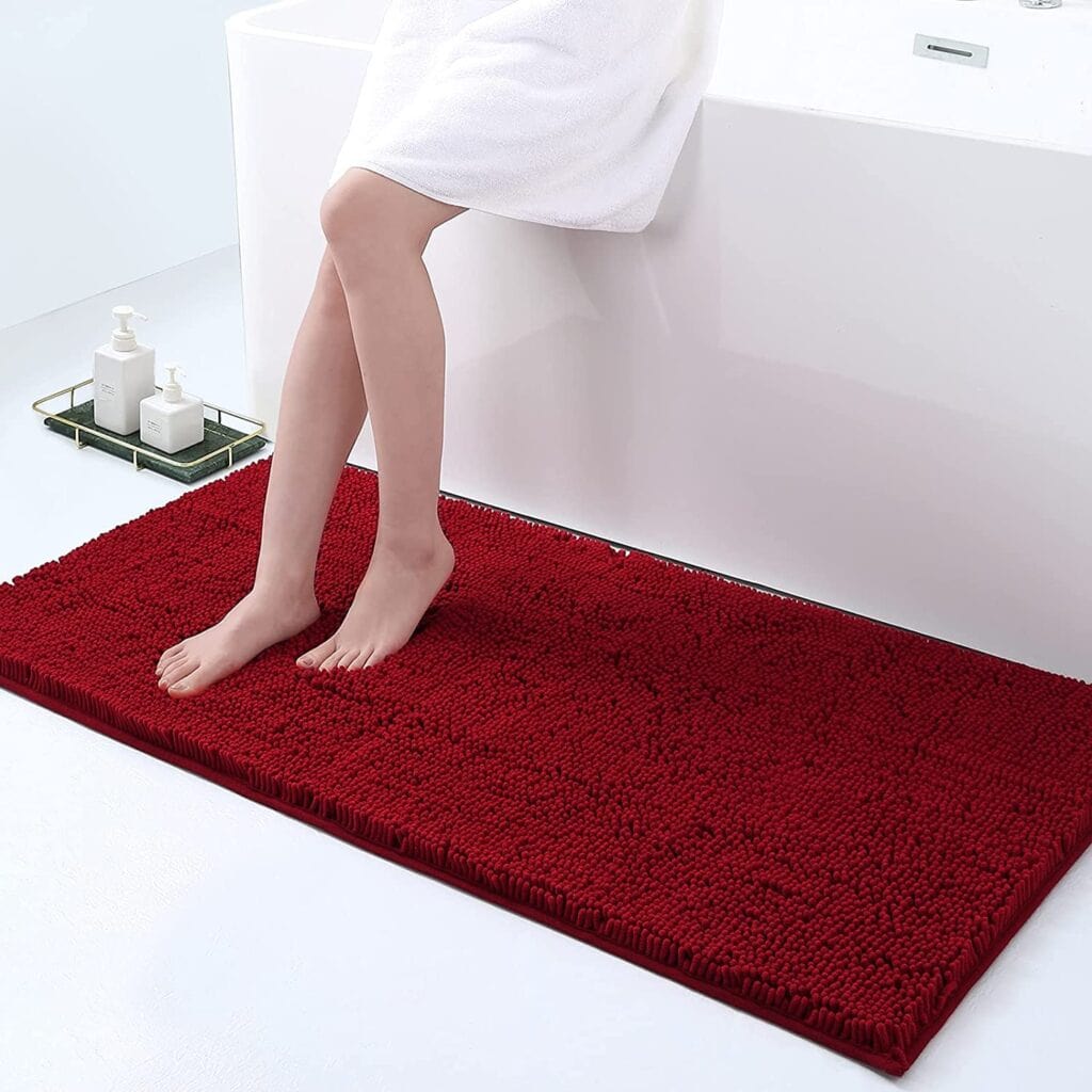 Large non-slip bath mat in red, cozy and absorbent for bathroom safety.