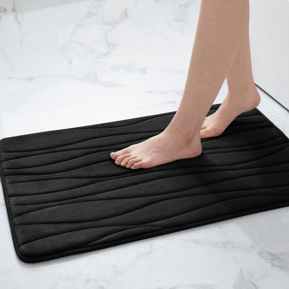 Large black water absorbent bath mat with ribbed texture for bathroom use.