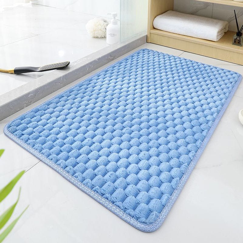 Light blue textured bath mat for bathroom comfort and style.