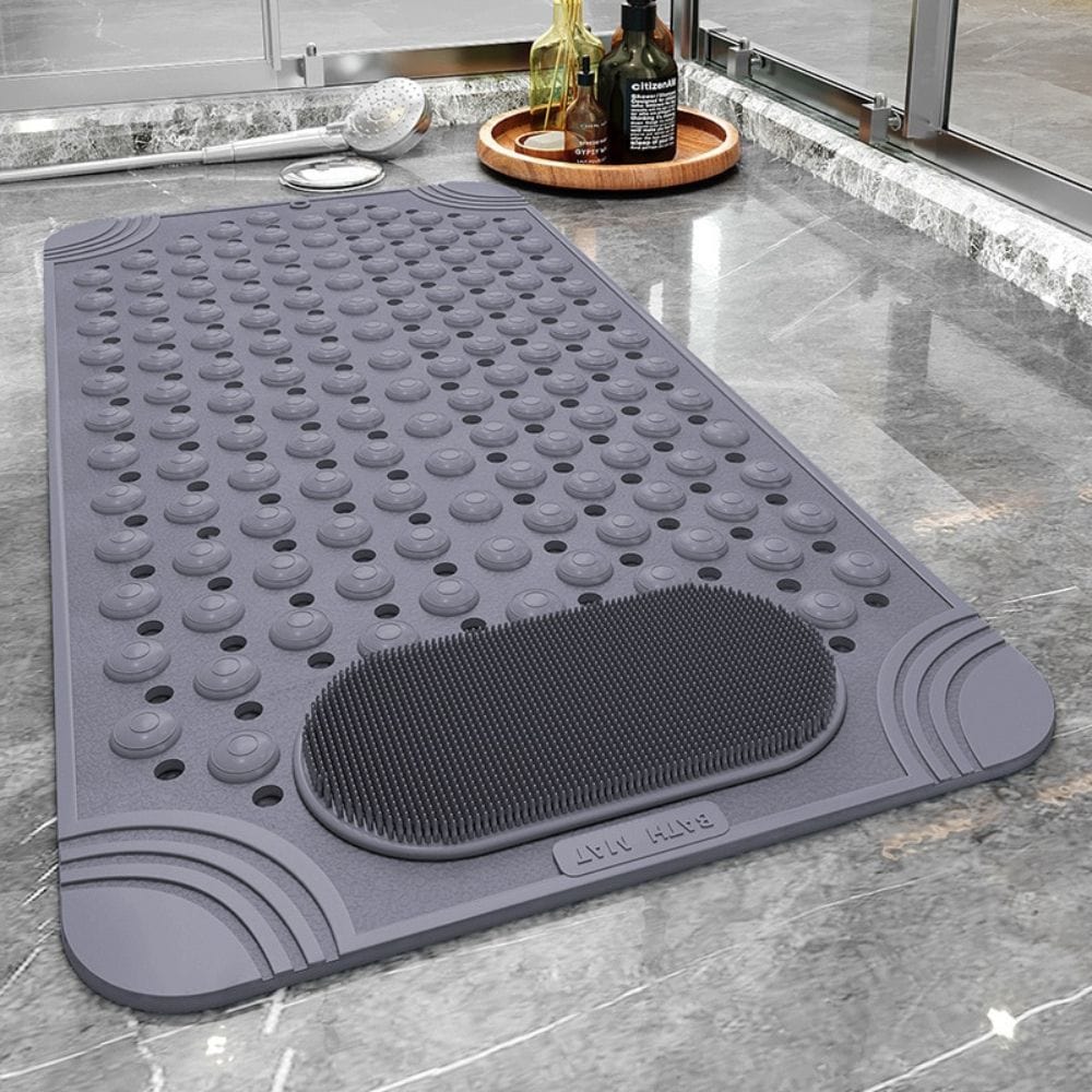 Long rectangular bath mat with massage bumps and scrubbing brush for bathroom.