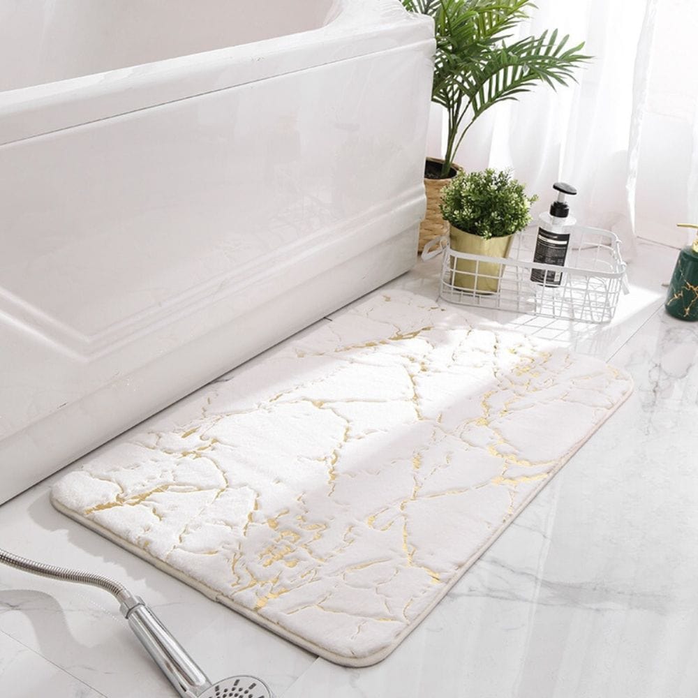 White marble effect bath mat with gold veins for luxury bathroom decor.