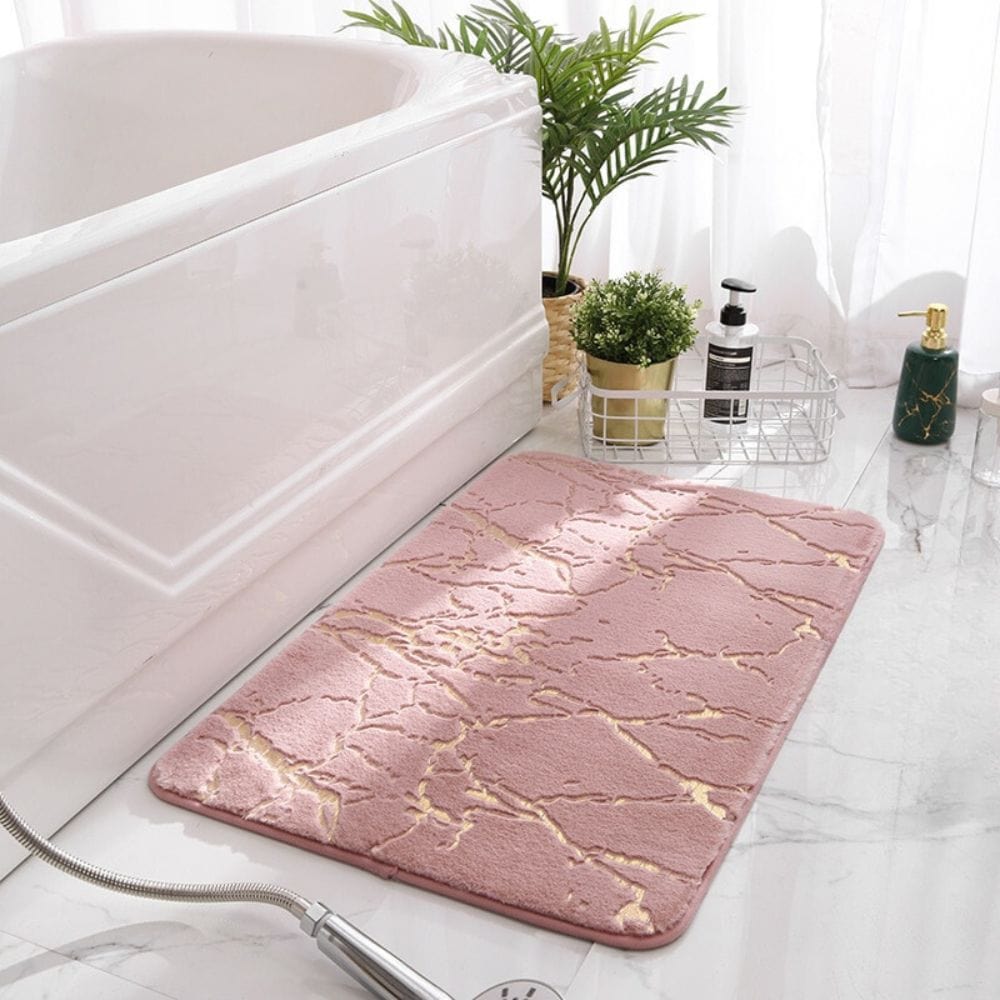 Pink marble effect bath mat with gold veins for luxury bathroom decor.