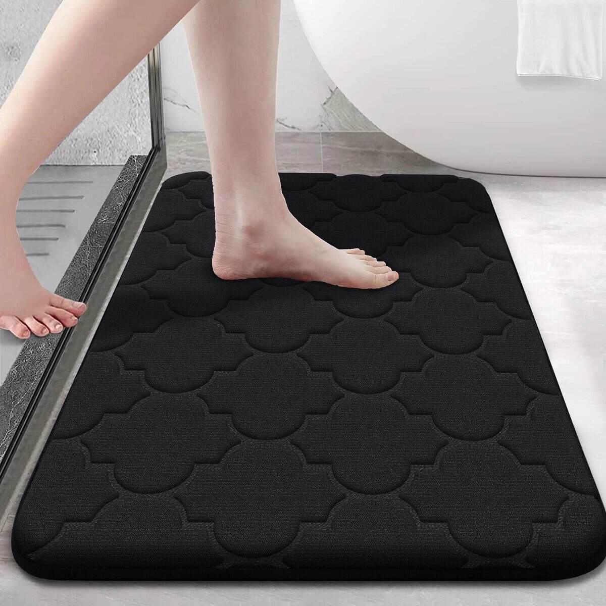 Black memory foam bath mat with quilted pattern for bathroom comfort and non-slip safety.