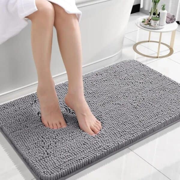 Gray micro chenille bath mat with feet resting on it.
