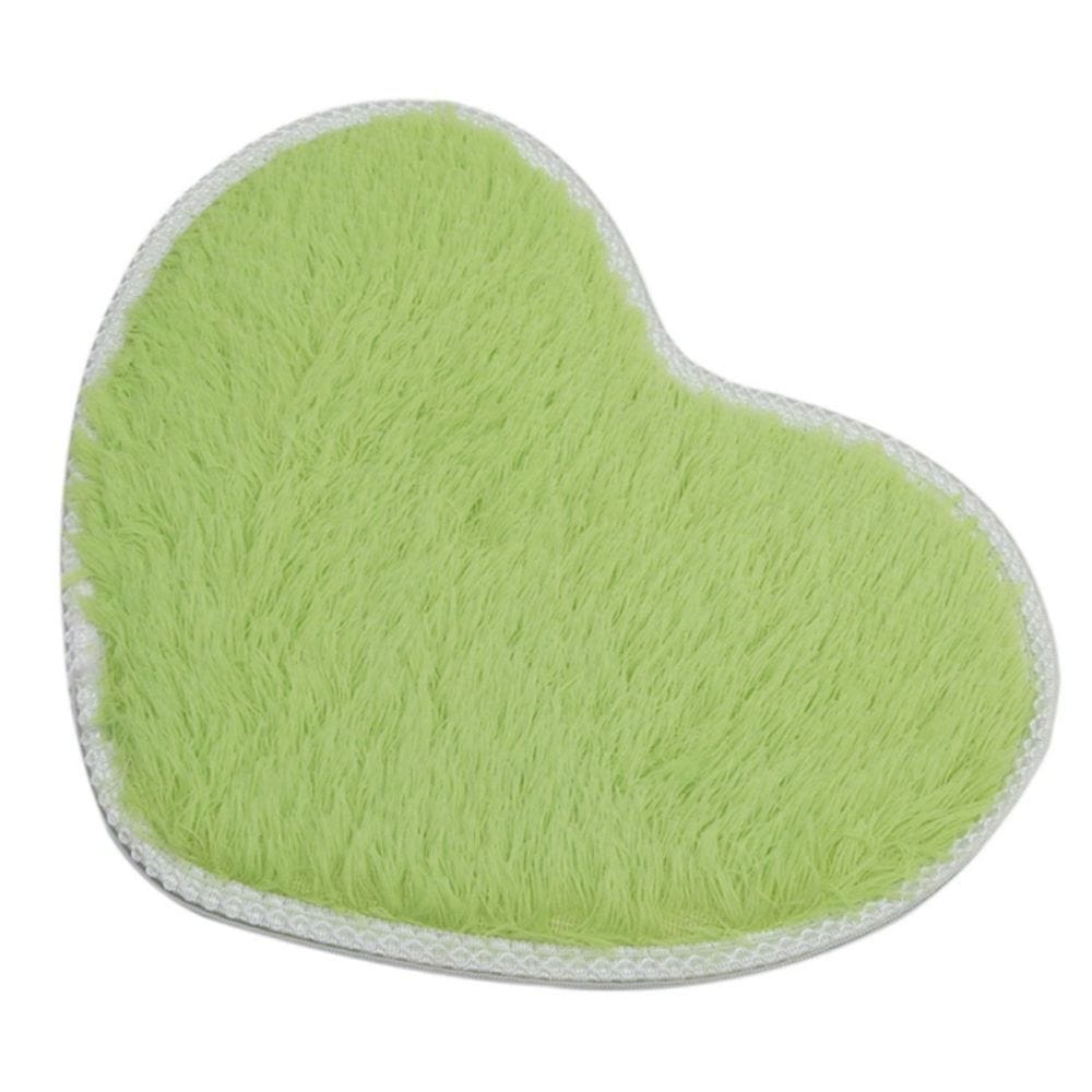 Heart-shaped microfiber chenille bath mat in light green with white trim.
