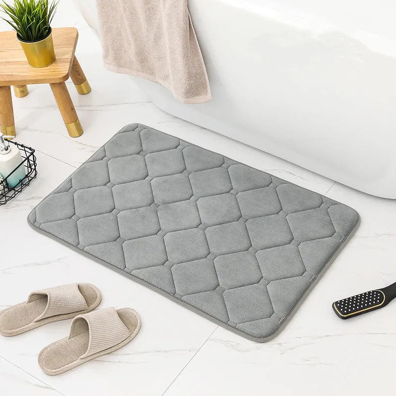 Gray microfiber memory foam bath mat with quilted design for comfort and grip.