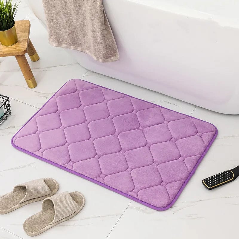 Purple microfiber memory foam bath mat with quilted design.