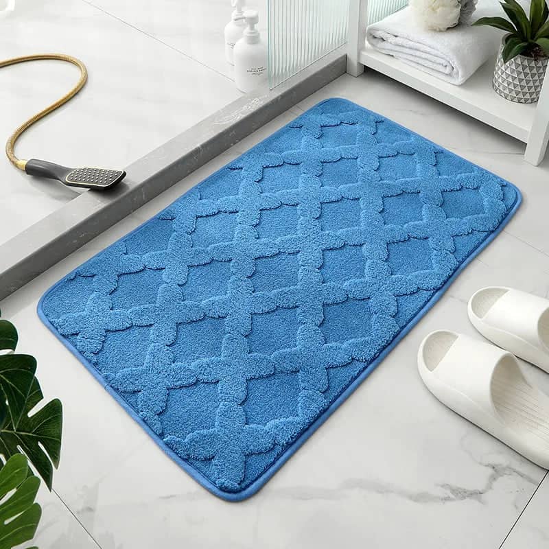 Blue microfibre bath mat with textured pattern for bathroom.