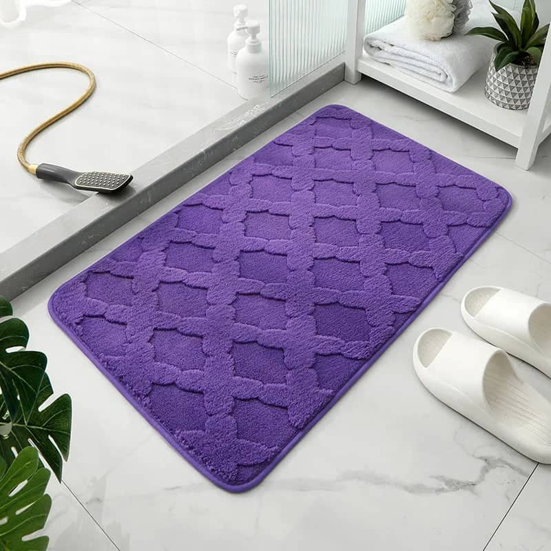 Purple microfibre bath mat with quilted pattern for bathroom.