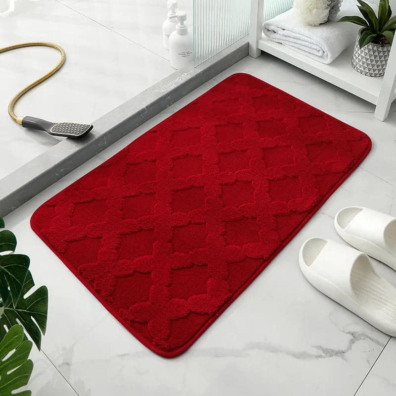 Red microfibre bath mat with diamond pattern for bathroom.