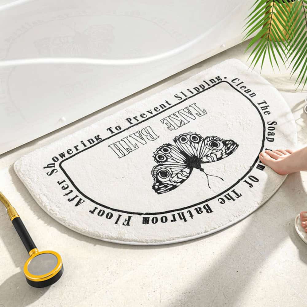 Moon-shaped bath mat with butterfly design for bathroom safety and style.