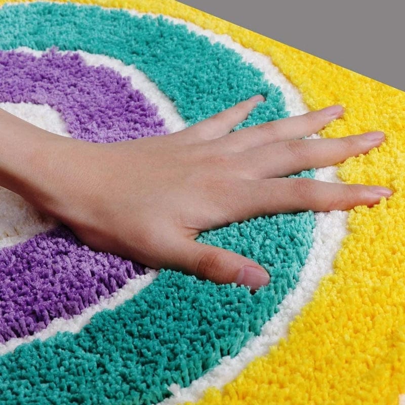 Multicoloured plush bath mat with hand touch for comfort.
