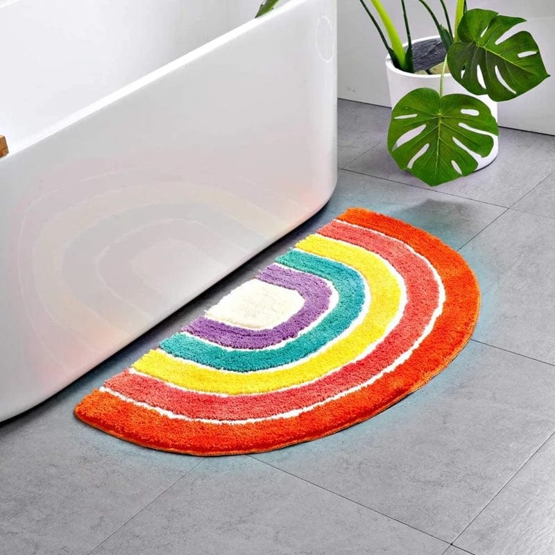 Multicoloured rainbow bath mat in semi-circle shape for bathroom.