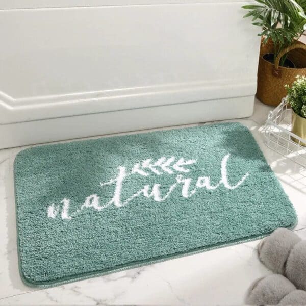 Green natural bath mat with white text design.