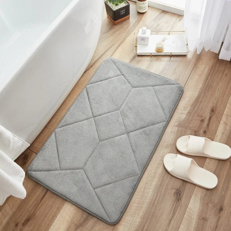 Grey non-slip bath mat with geometric stitching for bathroom safety.