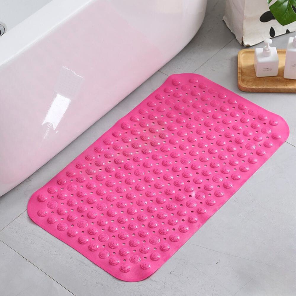 Pink non-slip bath mat with textured dots for safety in bathroom.