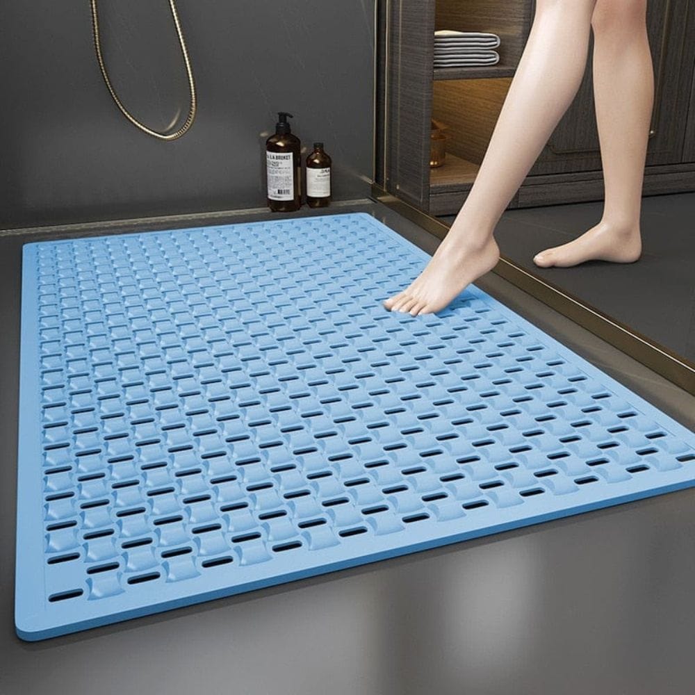 Blue non-slip shower bath mat with textured grip for safety in bathroom.