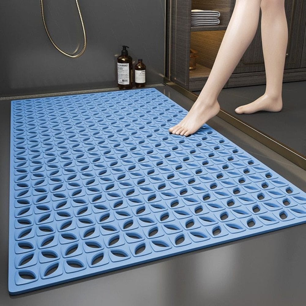 Blue non-slip shower bath mat with textured grip design.