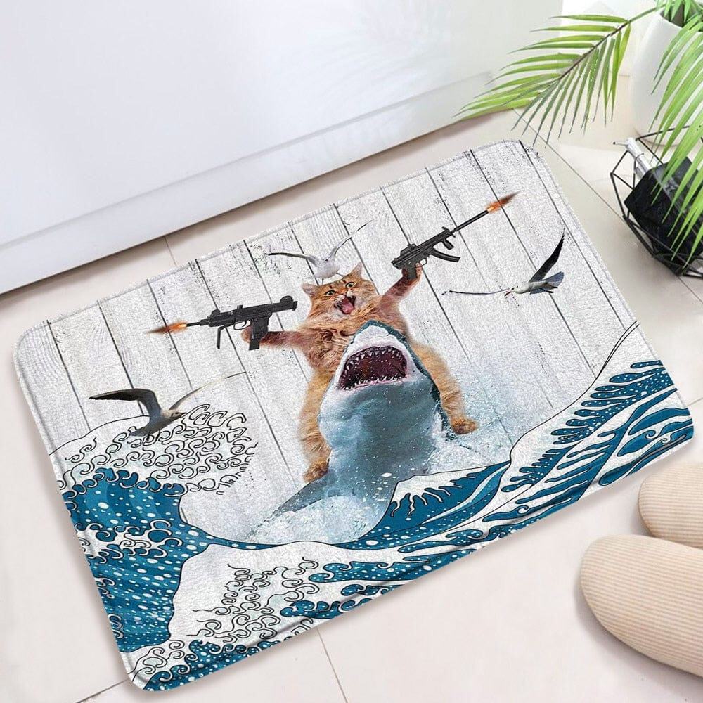 Funny novelty bath mat featuring cat with guns riding shark in wave design.