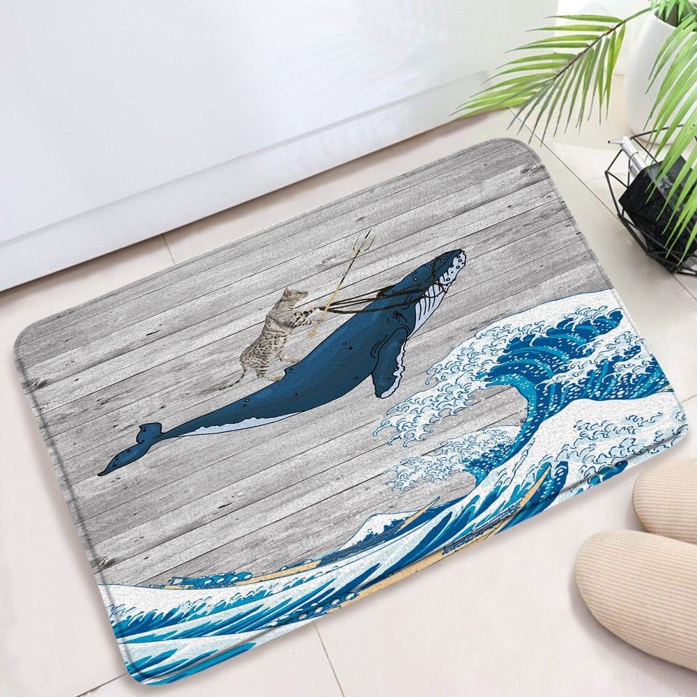 Novelty bath mat with cat riding whale in wave design.
