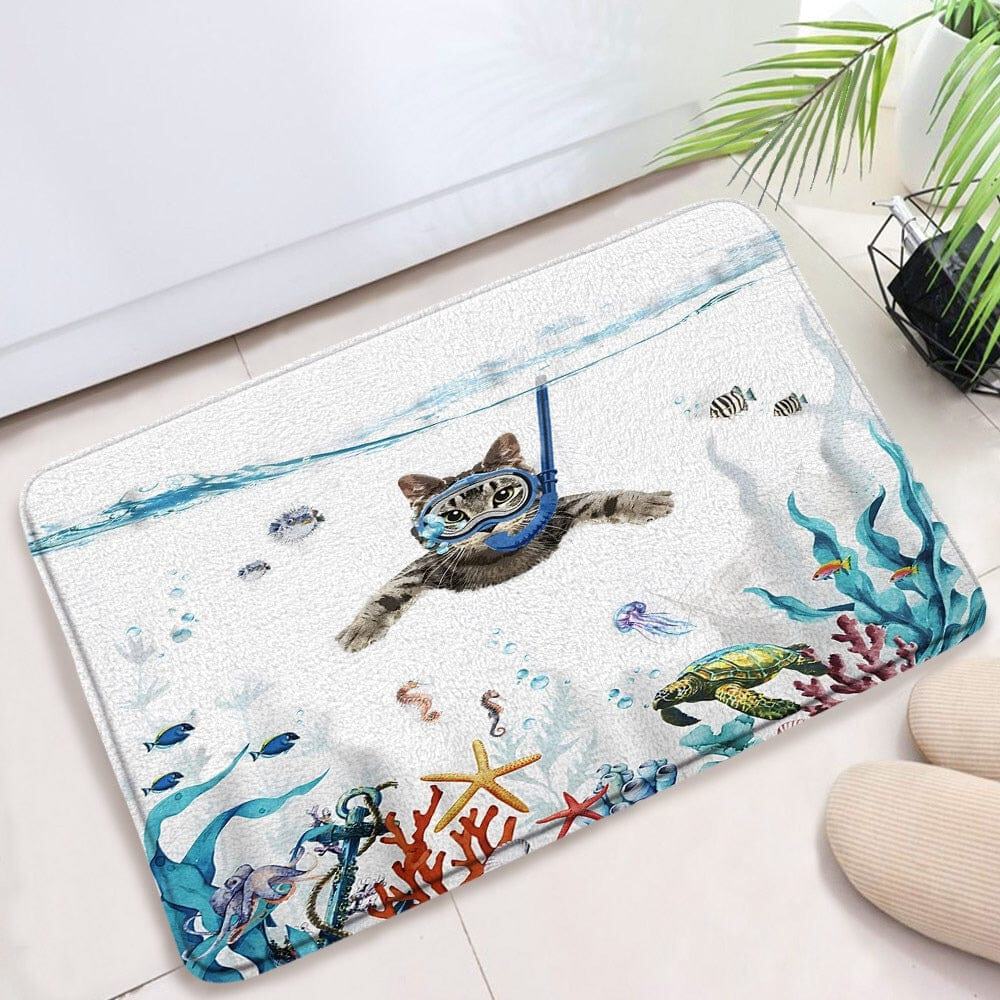 Novelty bath mat featuring cat scuba diving underwater with fish and coral.