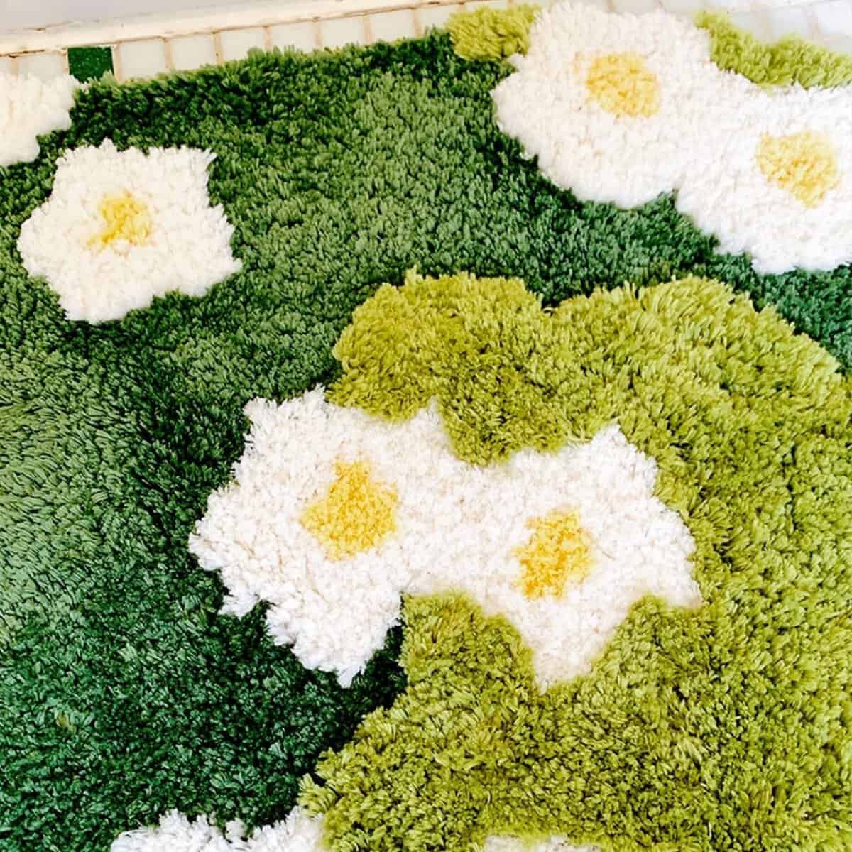 Organic Bath Mat with White Daisy Flowers and Green Grass Design.