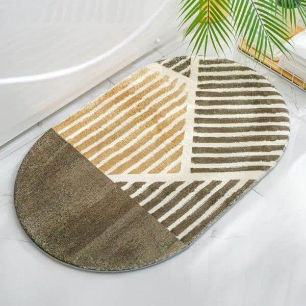 Oval bath mat with striped geometric pattern in earthy tones.