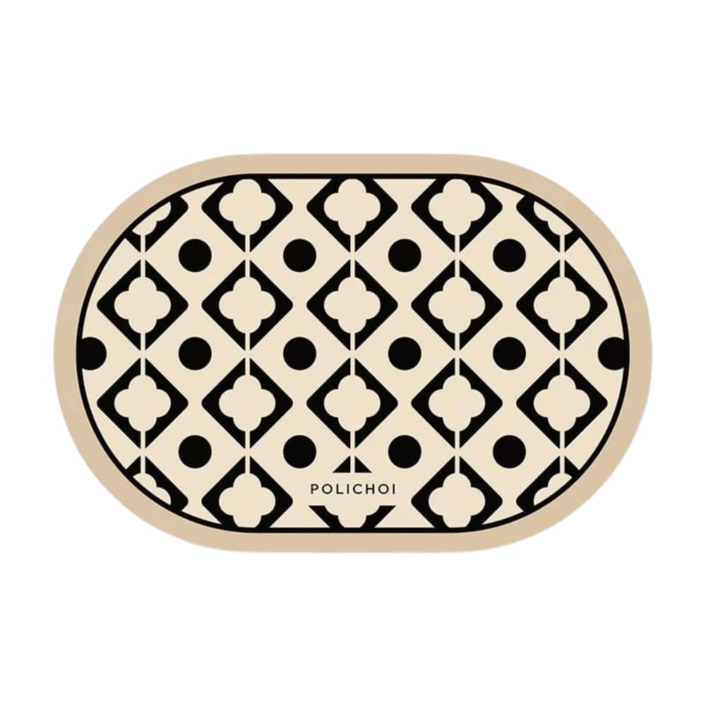 Oval bath mat with black and cream geometric pattern.