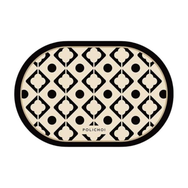 Oval bath mat with black and cream geometric pattern, Polichoi brand.
