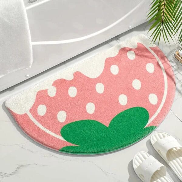 Pale pink watermelon slice bath mat for bathroom decor.