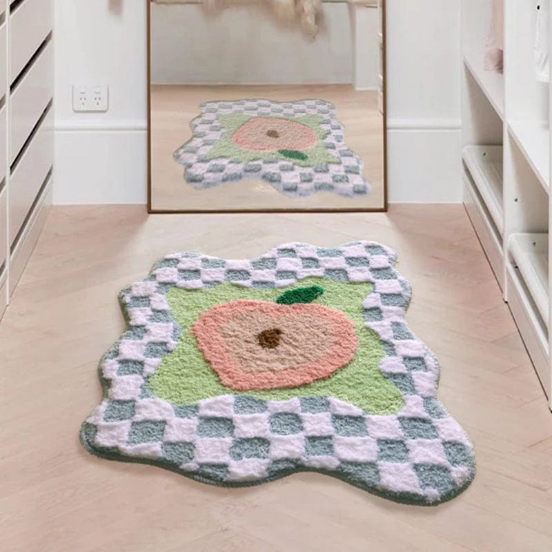Peach-themed bath mat with checkered border, soft plush texture.