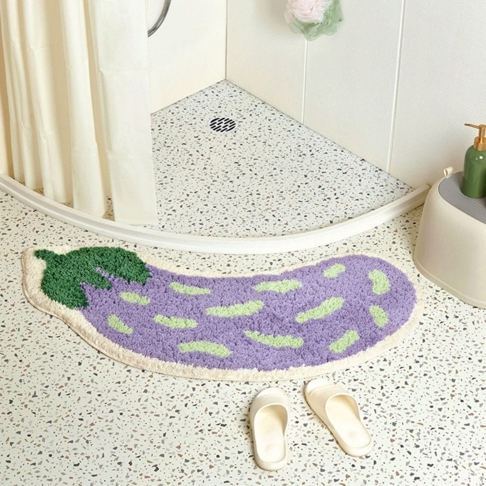 Purple eggplant-shaped bath mat in modern bathroom.