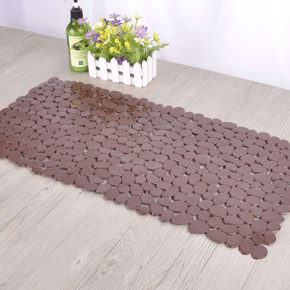 Brown plastic non-slip bath mat with pebble design for bathroom safety.