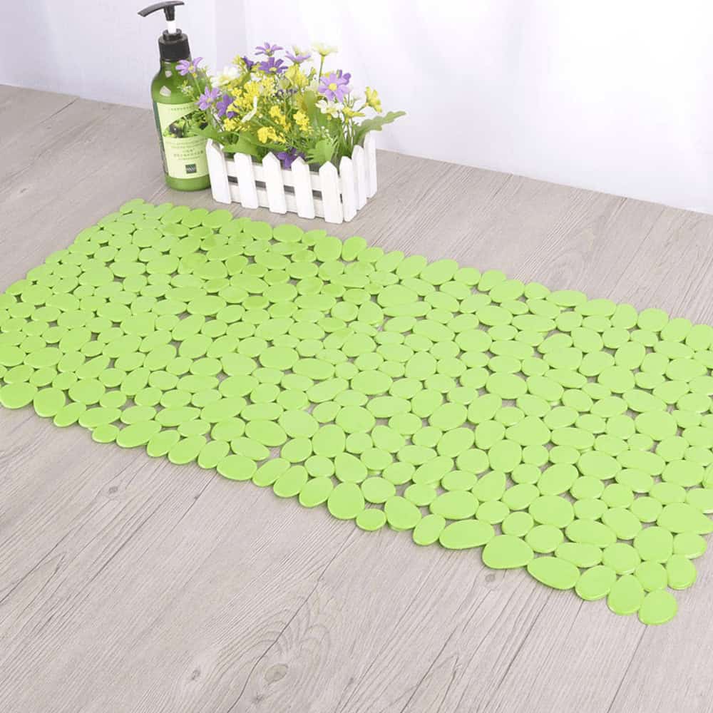 Green plastic non-slip bath mat with pebble design for bathroom safety.